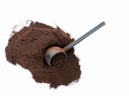 Isolated top view of pile of coffee grounds with scoopの写真素材