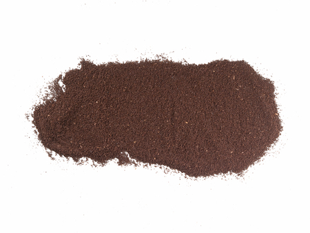 Isolated top view of ground coffee spread out on isolated surfaceの写真素材