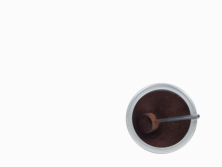 Isolated open can of ground coffee with scoop and negative spaceの写真素材