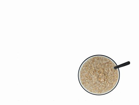 Top view of cooked steel cut oats in bowl on white backgroundの写真素材
