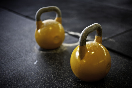 two yellow kettlebells in a crossfit gymの写真素材