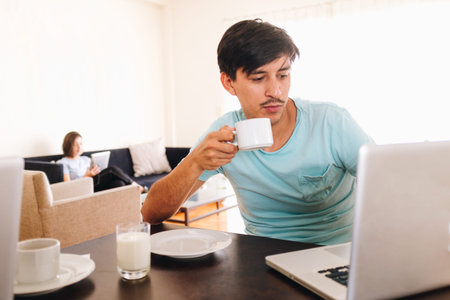 young couple interacting in bed with technology