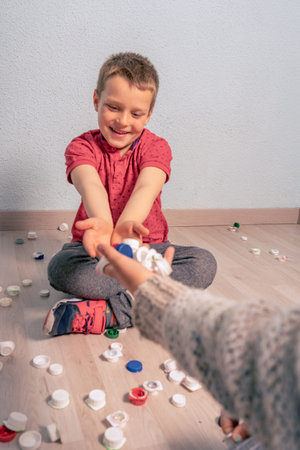 kids recycling and selecting plastic for recycling in garage or warehouse, fun, gamesの写真素材
