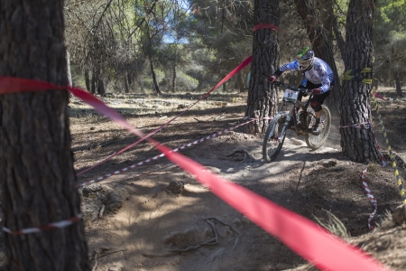 GRANADA, SPAIN - OCTOBER 25  Unknown racer on the competition of the mountain downhill bike  Cumbres Verdes, La Zubia  on October 25, 2012 in Granada, Spainのeditorial素材