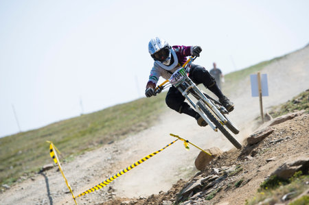 GRANADA, SPAIN - JUNE 30: Unknown racer on the competition of the mountain downhill bike Bull bikes...