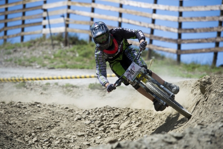 GRANADA, SPAIN - JUNE 30: Unknown racer on the competition of the mountain downhill bike "Bull bikes Cup DH 2013, Sierra Nevada " on June 30, 2013 in Granada, Spainのeditorial素材