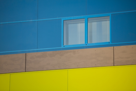 Modern office buildings. Colorful buildings in a industrial place. Blue and yellow windows.の写真素材
