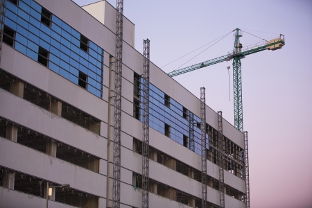 Construction site with crane whit purple sky at sunset.のeditorial素材