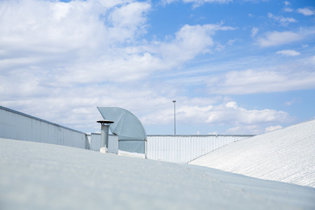 Four ventilation pipes over blue sky closeupの写真素材