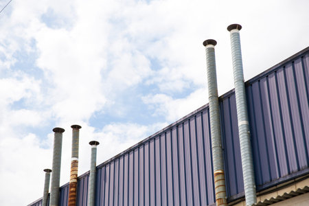 Six ventilation pipes over blue sky closeup