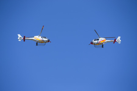 GRANADA,SPAIN - May 18: Aerobatic Spanish helicopter patrol (ASPA Patrol) perform at airshow (10Âº Aanniversary of Aspa Patrol in Granada) on May 18, 2014 in Granada ,Spainのeditorial素材