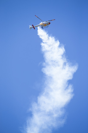 GRANADA,SPAIN - May 18: Aerobatic Spanish helicopter patrol (ASPA Patrol) perform at airshow (10Âº Aanniversary of Aspa Patrol in Granada) on May 18, 2014 in Granada ,Spainのeditorial素材