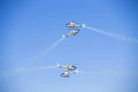 GRANADA,SPAIN - May 18: Aerobatic Spanish helicopter patrol (ASPA Patrol) perform at airshow (10Âº Aanniversary of Aspa Patrol in Granada) on May 18, 2014 in Granada ,Spainのeditorial素材