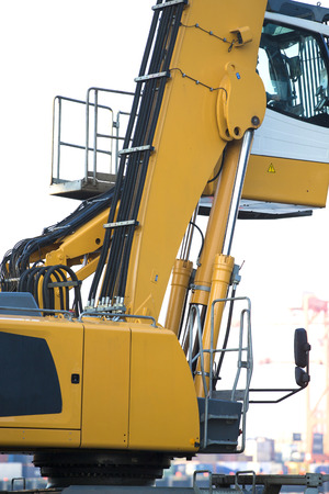 Large tracked excavator working a steel pile at a metal recycle yardの写真素材