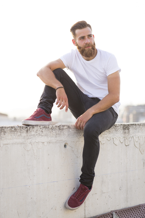 Bearded man sitting in the wall.の写真素材