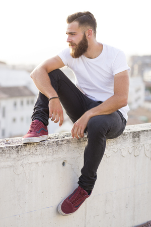 Bearded man sitting in the wall.の写真素材