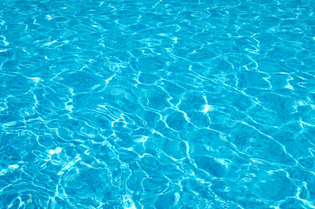 Blue pool water with sun reflections