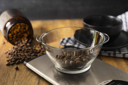 roasted coffee bean in a kitchen scaleの写真素材