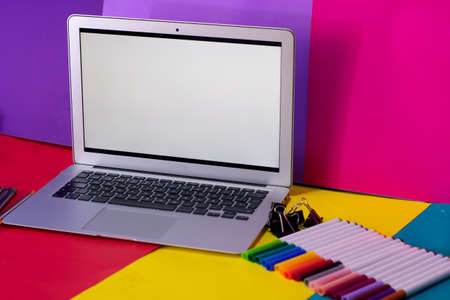 desk with Colorful pencils and pens in metal holder, close upの写真素材