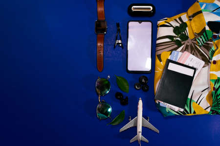 Top view of beach summer accessories with copy space. Lay flat holiday fashion background on blue background. Horizontal frameの写真素材