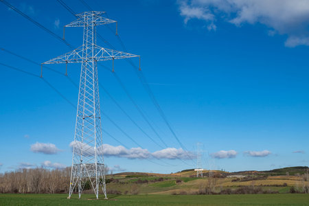 Electric pole, electricity tower station over blue sky and clouds. Horizontal format