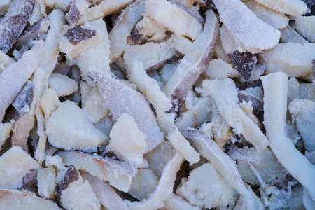 Top view of full frame background of heap of salted cod fillet slices on counter in local bazaarの写真素材