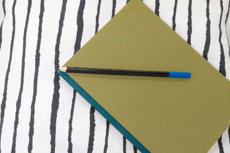 Yellow notebook with black pencil. Diary. plans. Be at home. Tranquilityの写真素材