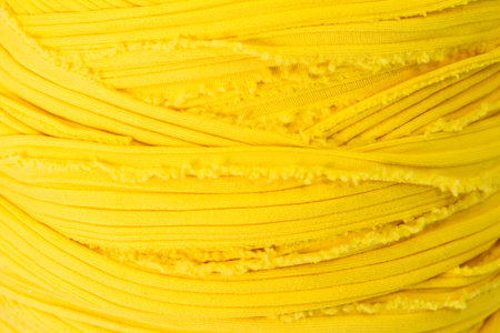 ball of yellow fabric for knitting. Close up.