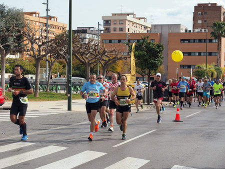 CastellÃ³n, Spain. February 26th, 2023. Group of athletes running a marathon in the city of Castellonのeditorial素材