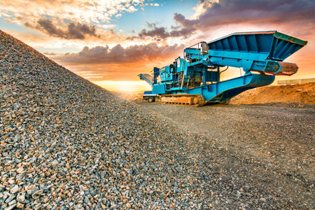 Stone crusher in a stone extraction mine. Heavy machinery to process stone