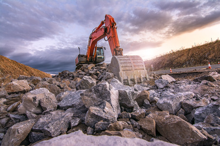 Excavator of great size extracting stone in an open-air mineの写真素材