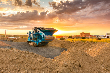 Stone crusher in a stone extraction mine. Heavy machinery to process stone