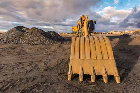 Gravel mountain in a quarry with heavy machinery for its movementの写真素材