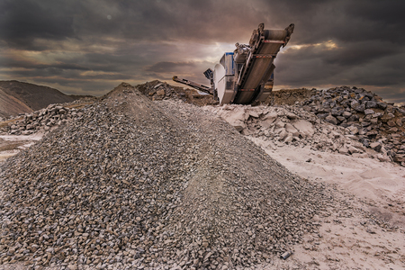 Mechanical conveyor belt to pulverize rock and stone and generate graveの写真素材