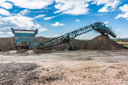 Recycling plant. Transforming asphalt from a gravel road to the construction of a new highwayの写真素材