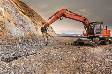 Hydraulic hammer drilling a granite wall
