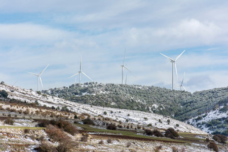 Windmills high on a mountain during winter in the interior of Spain