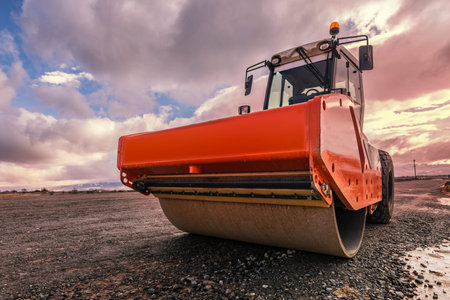 Steamroller performing road paving works