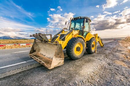 Repair of damaged sections of road with heavy machineryの写真素材