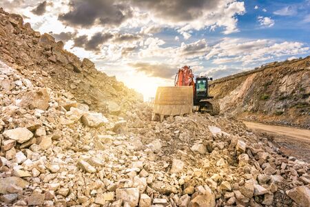 Construction site with an excavator moving rocの写真素材