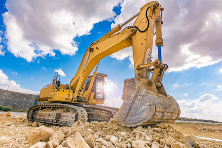 Excavator in a quarry extracting stone and rock
