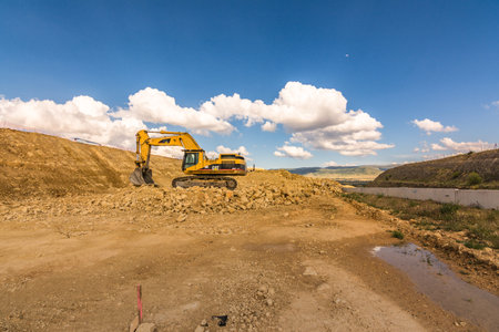 Excavator in a quarry extracting stone and rockの写真素材