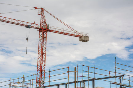 Scaffolding structure and a crane at a construction site