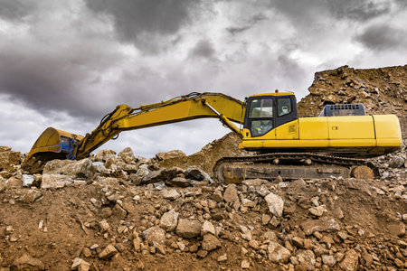 Heavy machinery moving stone and rock in an open mine