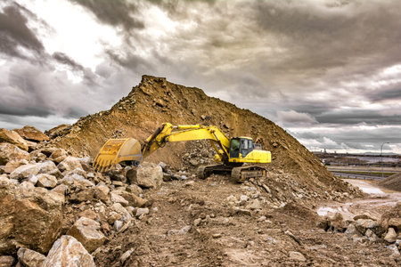 Heavy machinery moving stone and rock in an open mine
