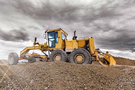 Heavy machinery moving stone and rock in an open mineの写真素材