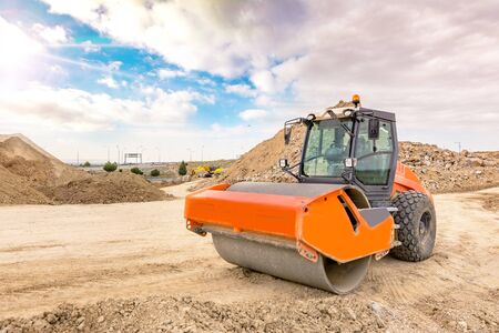 Steamroller performing earth compaction work for later asphaltingの写真素材