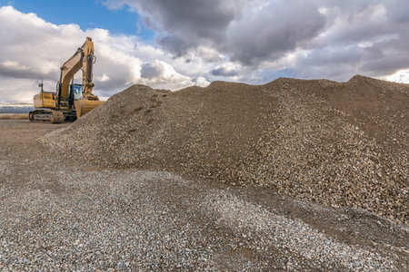 Excavator and heavy machinery for processing rock and stone in a quarry