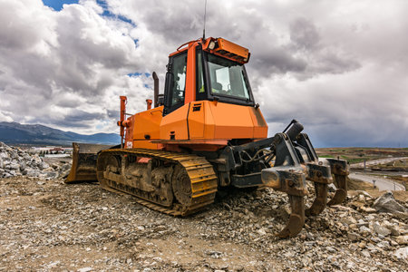 Excavator in a quarry extracting stone and rock