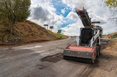 Repair and maintenance work on a road with machinery
